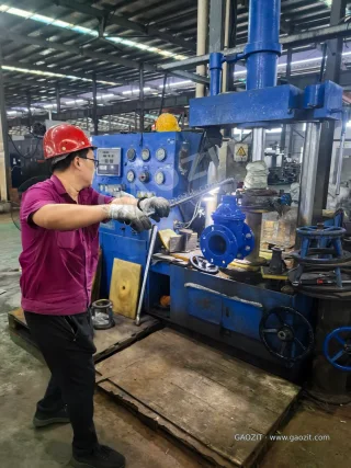 Manual torque-wrench operation on a gate valve in the test fixture.